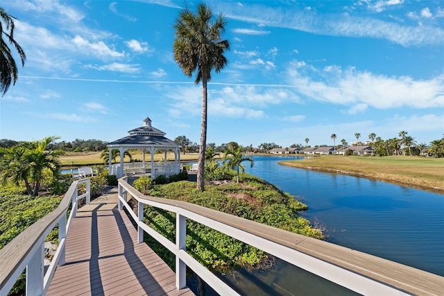 view of dock with a gazebo and a water view