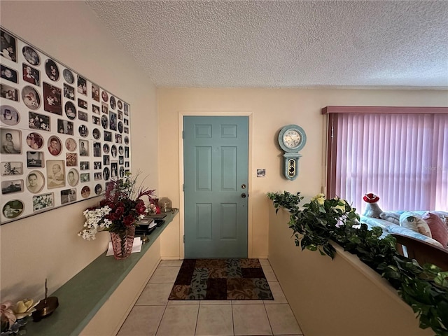 tiled foyer with a textured ceiling