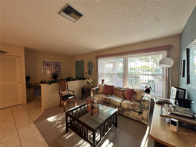 living room featuring light tile patterned floors and a textured ceiling