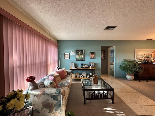 living room featuring light tile patterned flooring and a textured ceiling