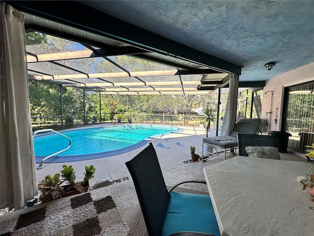 view of swimming pool with glass enclosure and a patio area