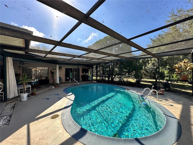 view of swimming pool with a lanai and a patio