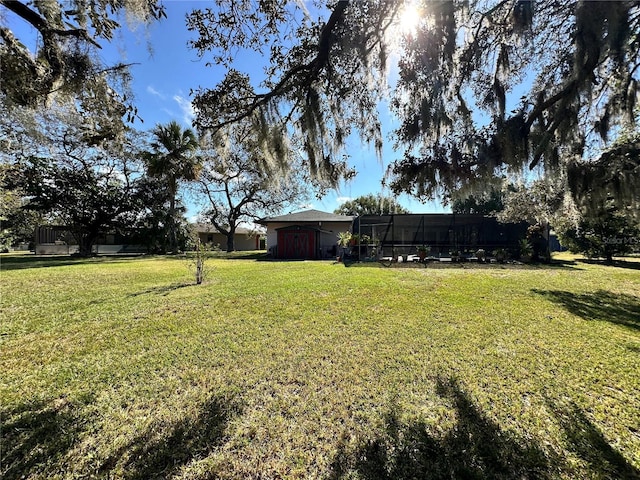 view of yard featuring glass enclosure