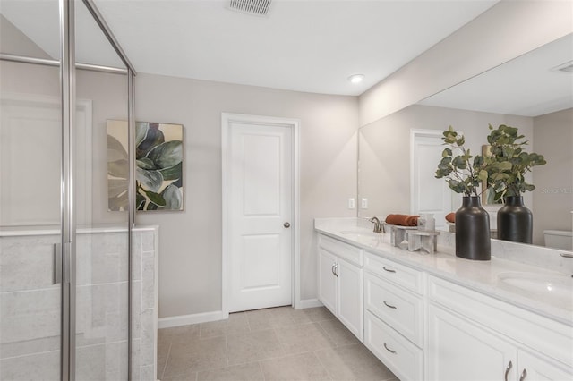 bathroom featuring a shower with door, vanity, and toilet