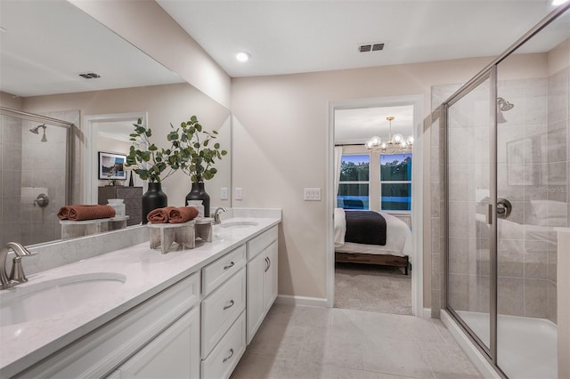 bathroom with a notable chandelier, vanity, and walk in shower