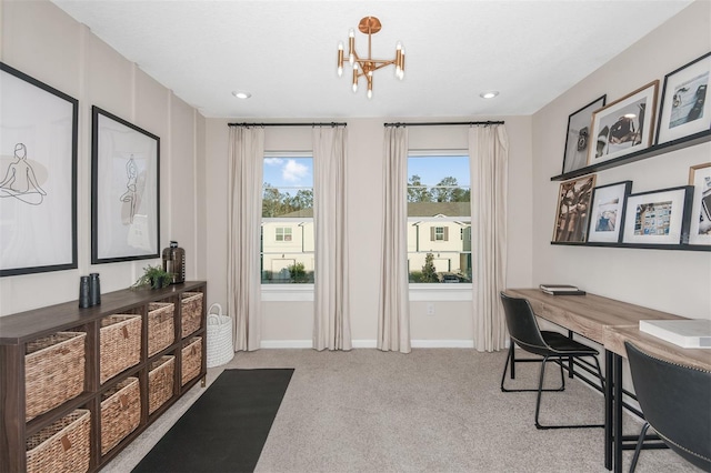 home office with light colored carpet and a notable chandelier