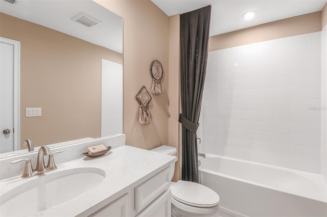 full bathroom featuring vanity, toilet, and shower / tub combo