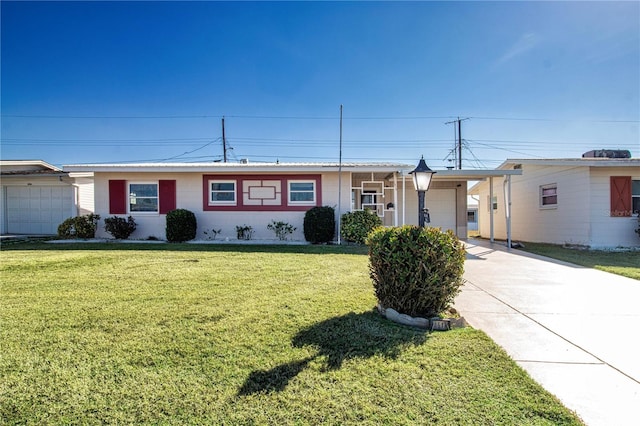 ranch-style house featuring a garage, a front yard, and a carport