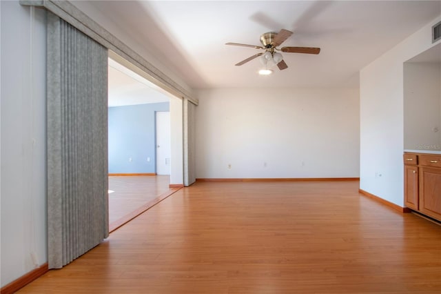 spare room featuring ceiling fan and light wood-type flooring