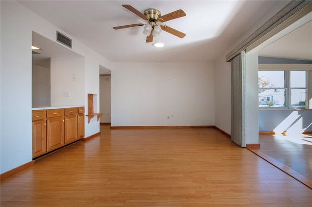 empty room featuring ceiling fan and light hardwood / wood-style floors