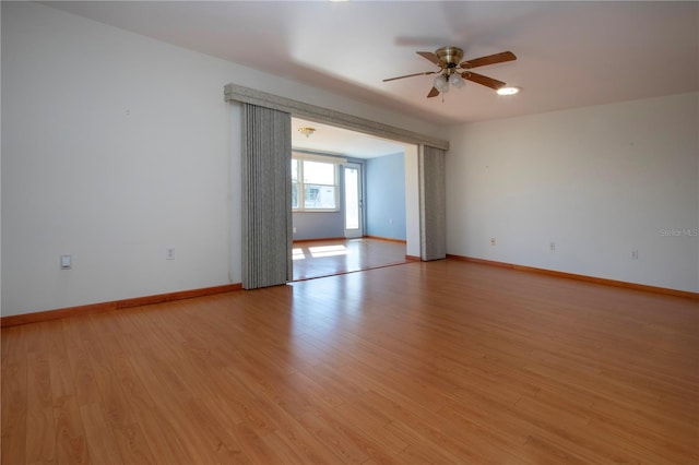 spare room featuring ceiling fan and light hardwood / wood-style floors