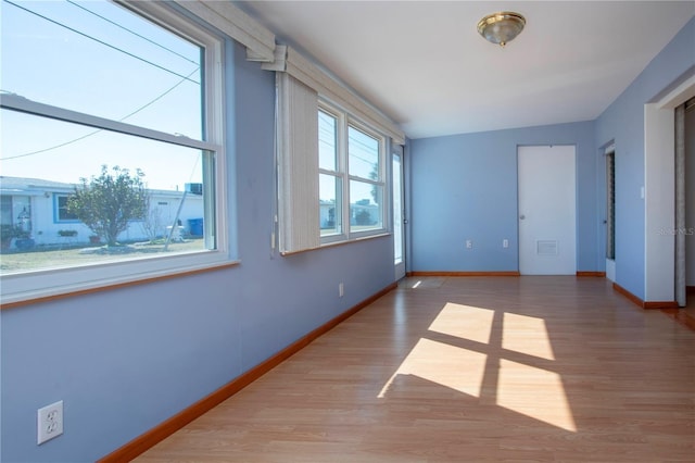 empty room with lofted ceiling and wood-type flooring