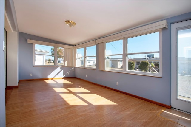 unfurnished sunroom with lofted ceiling and plenty of natural light