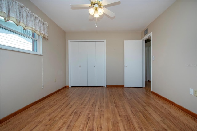 unfurnished bedroom with light hardwood / wood-style floors, ceiling fan, and a closet