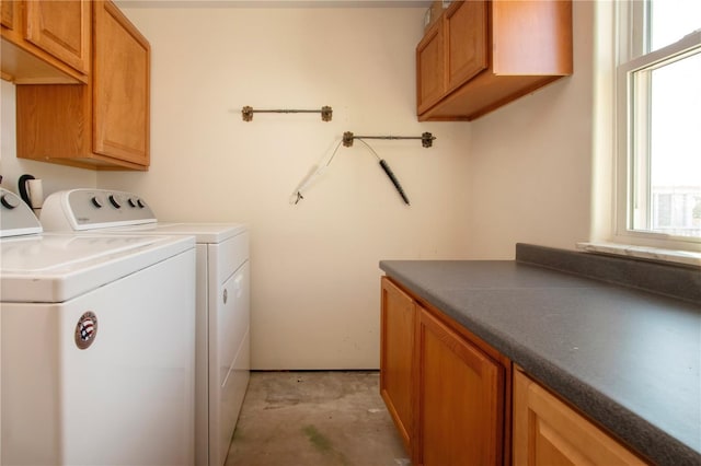 laundry area with washing machine and dryer and cabinets