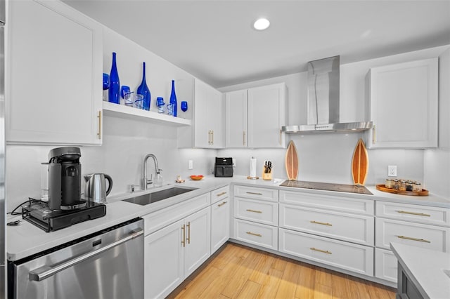 kitchen featuring sink, wall chimney range hood, stainless steel dishwasher, and white cabinets