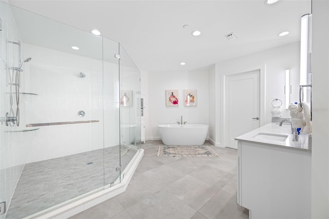 bathroom with independent shower and bath, tile patterned floors, and vanity