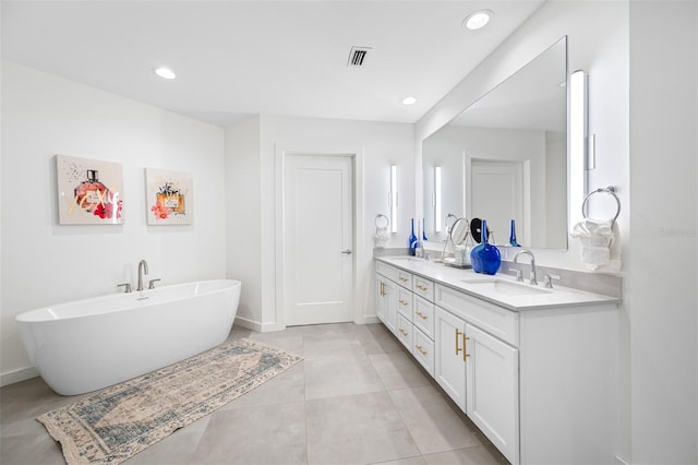 bathroom featuring tile patterned flooring, vanity, and a bathtub