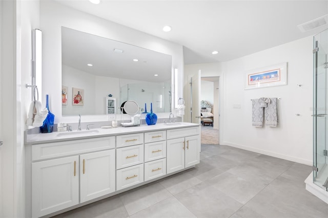 bathroom with a shower with shower door and vanity