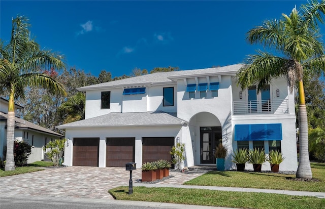 view of front of house featuring a balcony and a garage