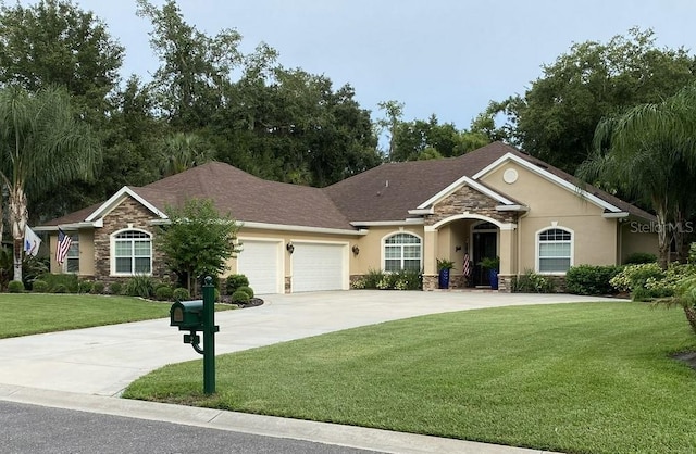 single story home featuring a garage and a front yard