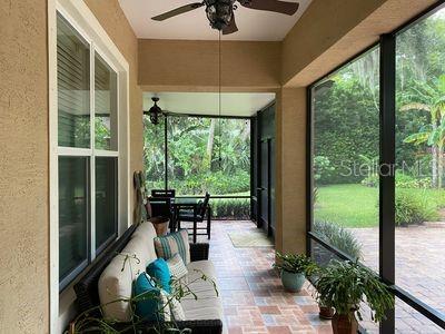 unfurnished sunroom with ceiling fan