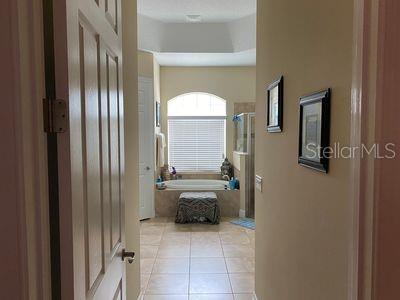 hallway featuring light tile patterned flooring