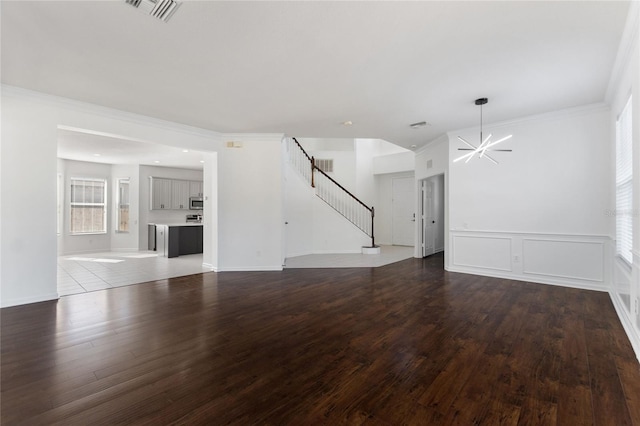 unfurnished living room with hardwood / wood-style flooring and ornamental molding