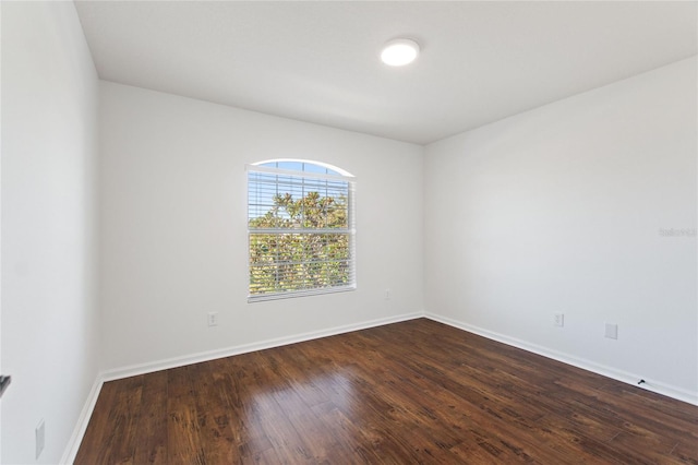 spare room featuring dark wood-type flooring