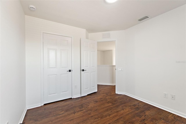 unfurnished bedroom featuring dark wood-type flooring