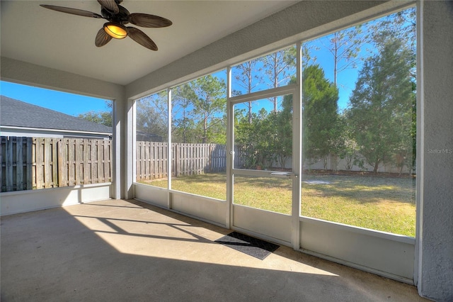 unfurnished sunroom with ceiling fan and a healthy amount of sunlight