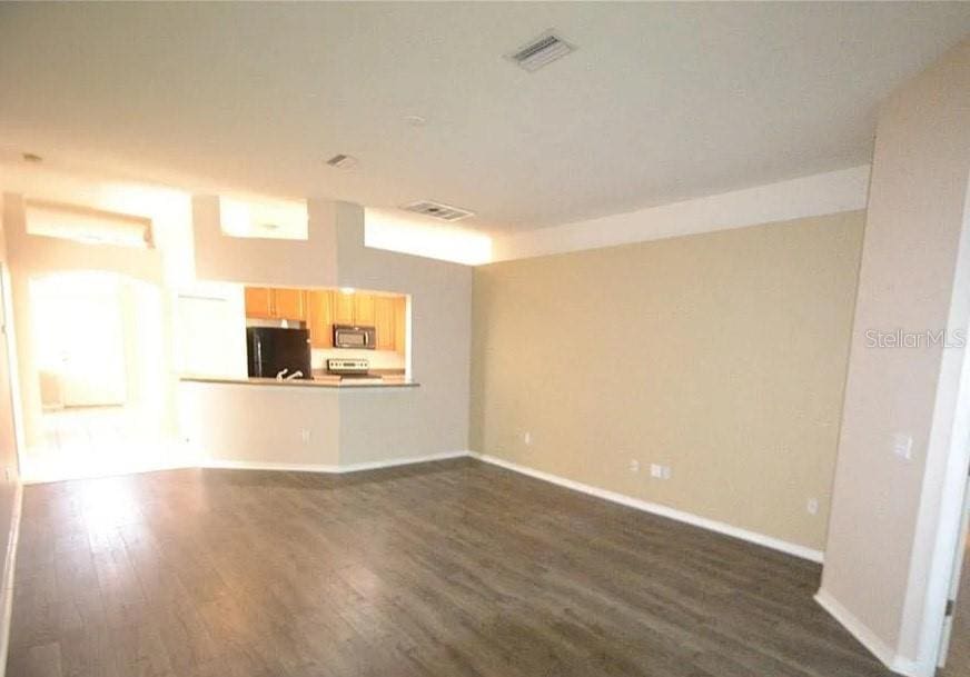 unfurnished living room featuring dark hardwood / wood-style flooring