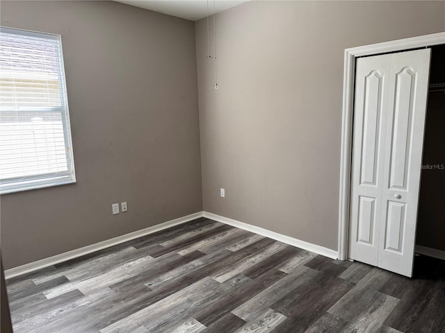 spare room with dark hardwood / wood-style floors