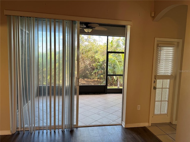 doorway to outside with wood-type flooring and ceiling fan