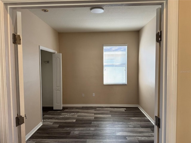 unfurnished bedroom with dark wood-type flooring