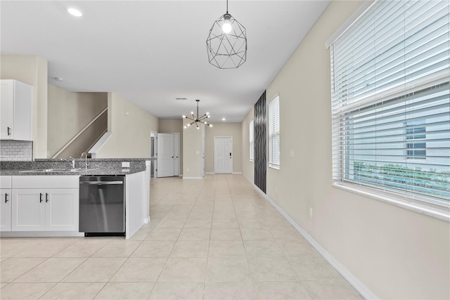 kitchen featuring white cabinetry, dishwasher, sink, hanging light fixtures, and a notable chandelier