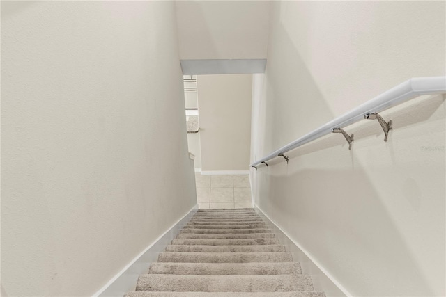 stairs featuring tile patterned flooring