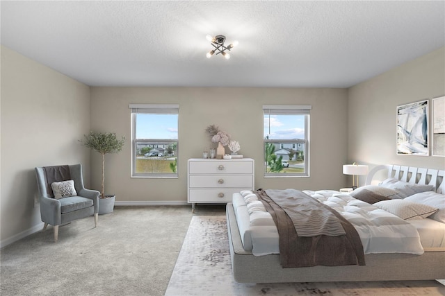 bedroom with light carpet and a textured ceiling