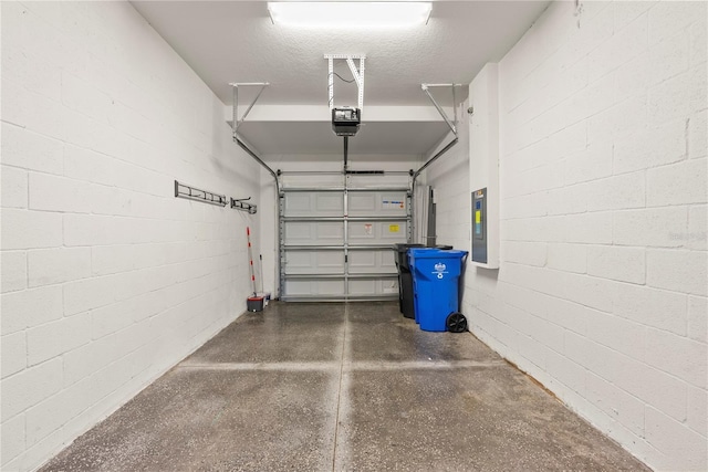 garage featuring electric panel and a garage door opener