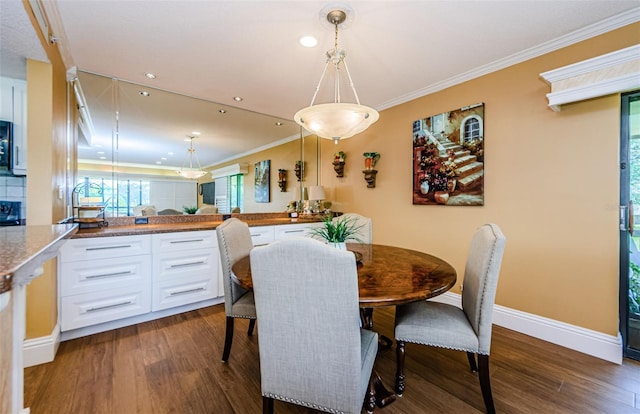 dining room featuring dark hardwood / wood-style floors and ornamental molding