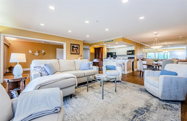 living room featuring hardwood / wood-style flooring and ornamental molding