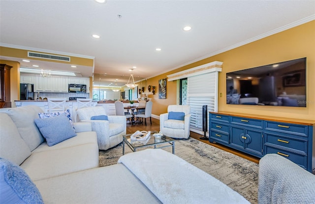 living room featuring wood-type flooring and ornamental molding