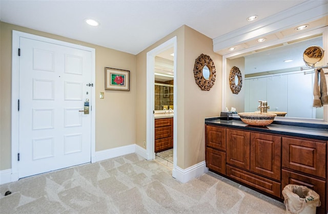 carpeted entrance foyer featuring sink