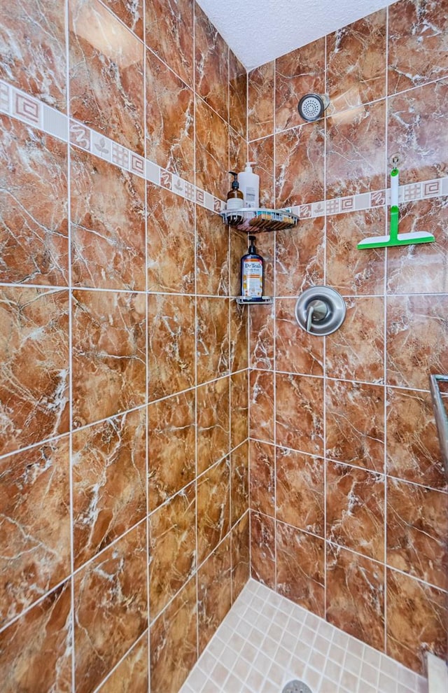 bathroom with a tile shower