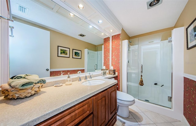 bathroom featuring tile patterned floors, vanity, toilet, and a shower with shower door