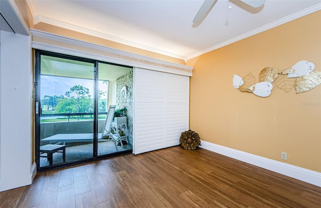 spare room with hardwood / wood-style flooring, ceiling fan, and ornamental molding