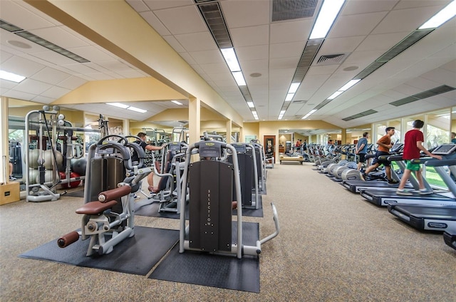 gym with dark colored carpet and a drop ceiling