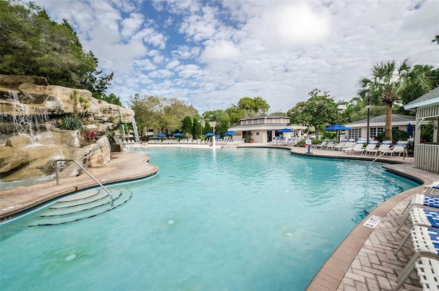 view of pool with pool water feature and a patio area