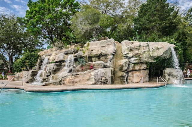 view of pool with pool water feature