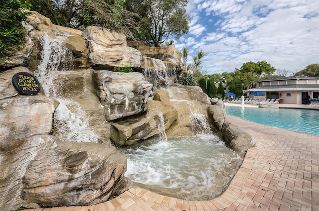 view of pool with pool water feature